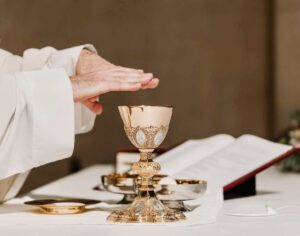 Priest at Mass with hands over chalice at the consecration